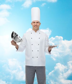 cooking, profession and people concept - happy male chef cook opening cloche cover over blue sky with clouds background