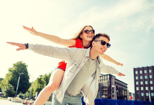 holidays, vacation, love and friendship concept - smiling couple having fun in city