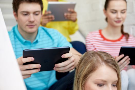 education, technology, people and internet concept - close up of students with tablet pc computers at school