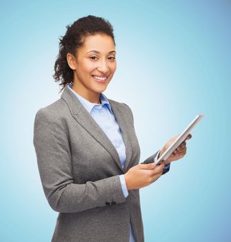 business, education, people and technology concept - smiling african american woman holding tablet pc computer over blue background