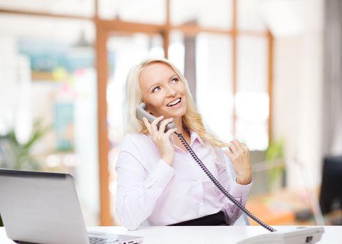 education, business, communication and technology concept - smiling businesswoman or student with laptop computer calling on phone over office room background