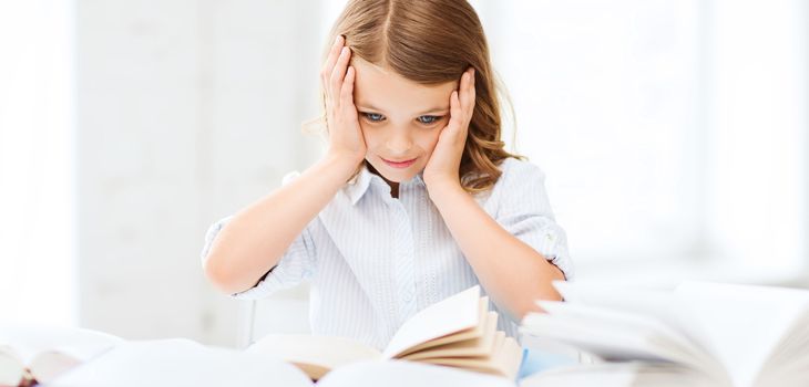 education and school concept - little student girl with many books at school