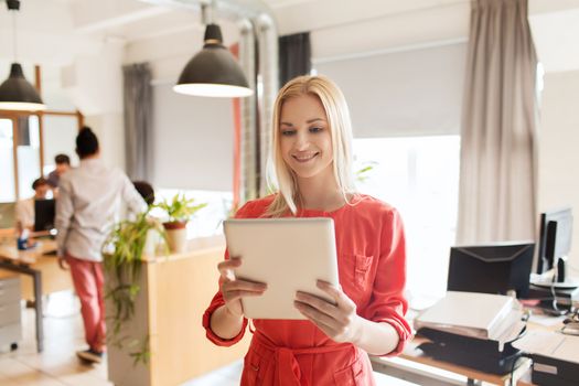 business, startup and people concept - happy businesswoman or creative female office worker with tablet pc computer