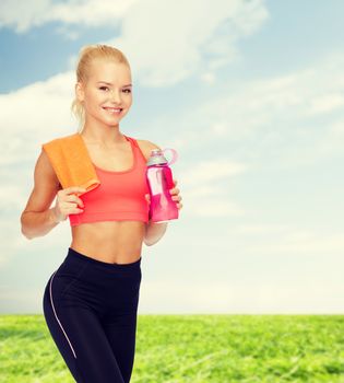 sport, exercise and healthcare concept - sporty woman with orange towel and water bottle