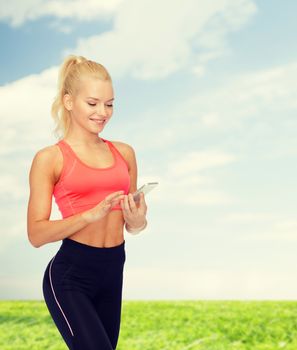 sport, fitness, technology, internet and healthcare concept - smiling sporty woman with smartphone