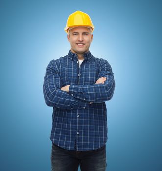 repair, construction, building, people and maintenance concept - smiling male builder or manual worker in helmet over blue background