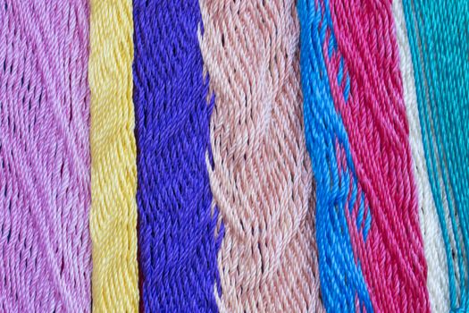 Macro closeup intricate nylon weave of multi-colored Mexican hammock