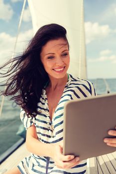 vacation, holidays travel, sea and technology concept - smiling woman sitting on yacht with tablet pc