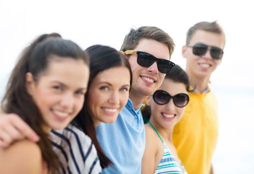 summer holidays, vacation, tourism, travel and people concept - group of happy friends on beach