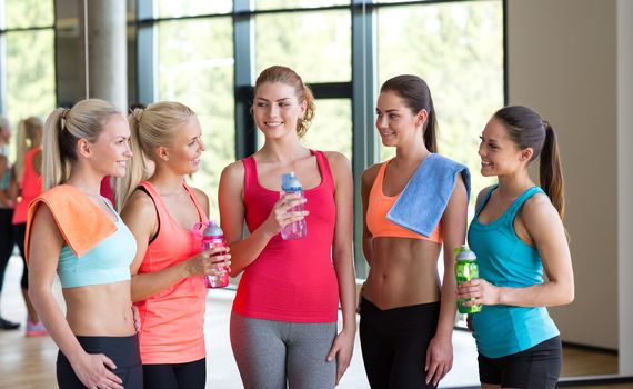 fitness, sport, training, gym and lifestyle concept - group of women with bottles of water in gym
