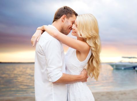 summer holidays, people, love and dating concept - happy couple hugging over sunset at summer beach background