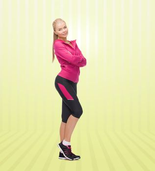 sport, fitness, people and weight loss concept - beautiful sporty young woman over yellow striped background