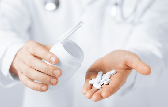 picture of doctor hands holding white pack and pills