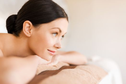 picture of woman in spa salon lying on the massage desk