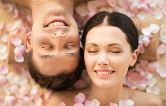 faces of couple in spa salon lying on the massage desks