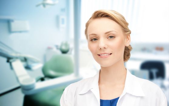 people, medicine, stomatology and healthcare concept - happy young female dentist with tools over medical office background