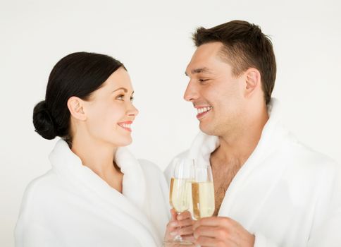 picture of couple in spa salon in white bathrobes with champagne