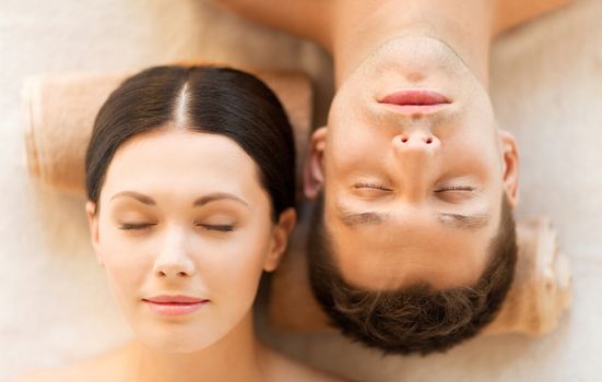 picture of couple in spa salon lying on the massage desks