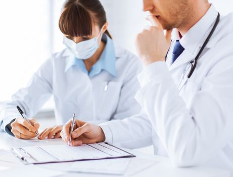 picture of doctor and nurse writing prescription paper