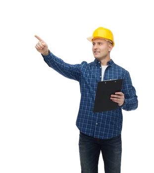 repair, building, construction and maintenance concept - smiling man or builder in helmet with clipboard pointing finger