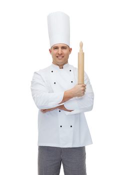 cooking, profession and people concept - happy male chef cook holding rolling pin