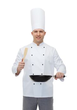 cooking, profession and people concept - happy male chef cook holding frying pan and spatula