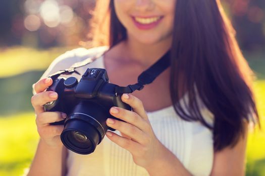 lifestyle, summer, vacation, technology and people concept - close up of young girl with photo camera outdoors