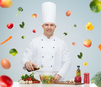 profession, vegetarian, food and people concept - happy male chef cooking vegetable salad over gray background