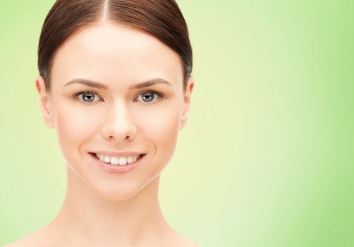 health, people, eco and beauty concept - beautiful young woman face over green background