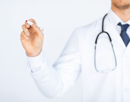 close up of doctor writing something in the air with marker