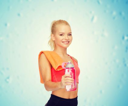 sport, exercise and healthcare - sporty woman with orange towel and water bottle