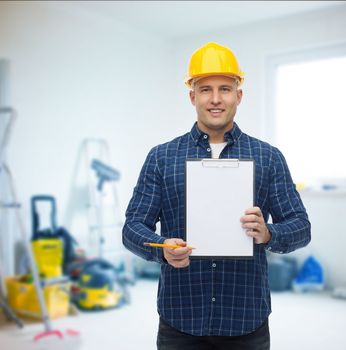 repair, construction, building, people and maintenance concept - smiling male builder or manual worker in helmet with clipboard over room with work equipment background