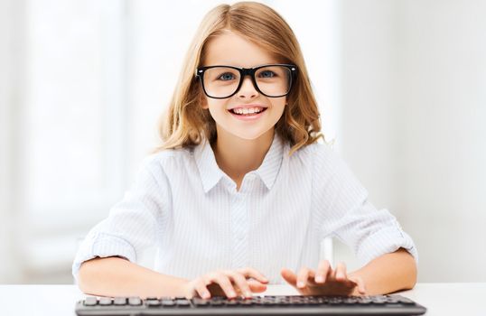 education, school and future technology concept - little student girl with keyboard and imaginary screen at school