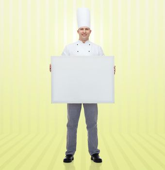 cooking, profession, advertisement and people concept - happy male chef cook holding and showing white blank big board over yellow background