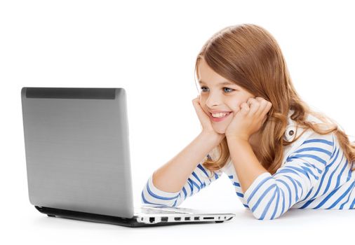 education, technology and internet concept - smiling little student girl with laptop computer lying on the floor