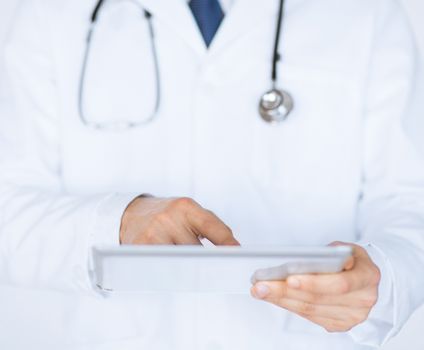 close up of male doctor holding tablet pc