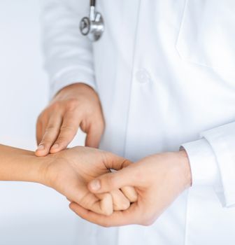 close up of doctor measuring patient heart beat