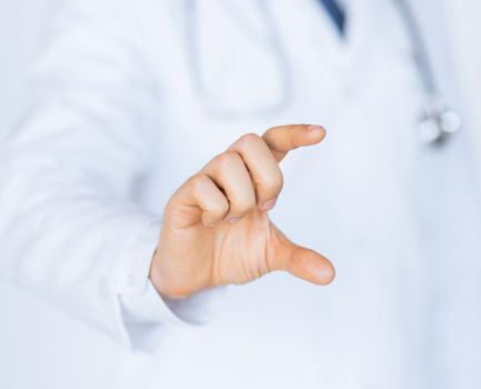 close up of male doctor holding something in his hand