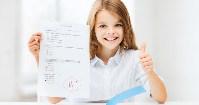 education and school concept - little student girl with test and A grade showing thumbs up at school