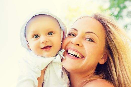 family, child and parenthood concept - happy mother with little baby outdoors