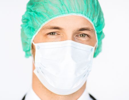 picture of half face of surgeon in medical cap and mask