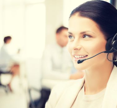 friendly female helpline operator with headphones in call center