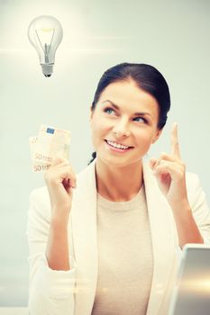 happy woman with cash euro money and light bulb