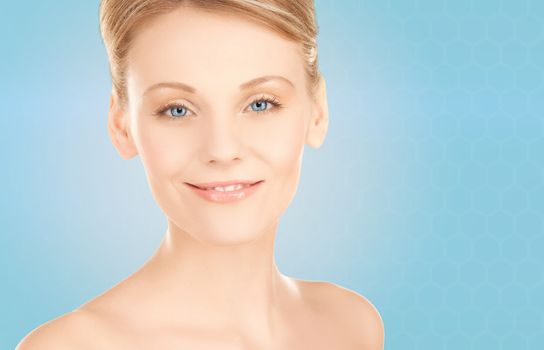 beauty, people and health concept - beautiful young woman face over blue background