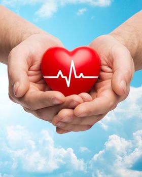 family health, charity and medicine concept - close up of hands holding red heart with cardiogram over blue sky and clouds background