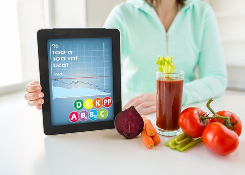 healthy eating, technology, diet and people concept - close up of woman hands holding tablet pc computer with calories and vitamins chart, vegetables