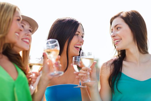 summer holidays, vacation and celebration - girls with champagne glasses