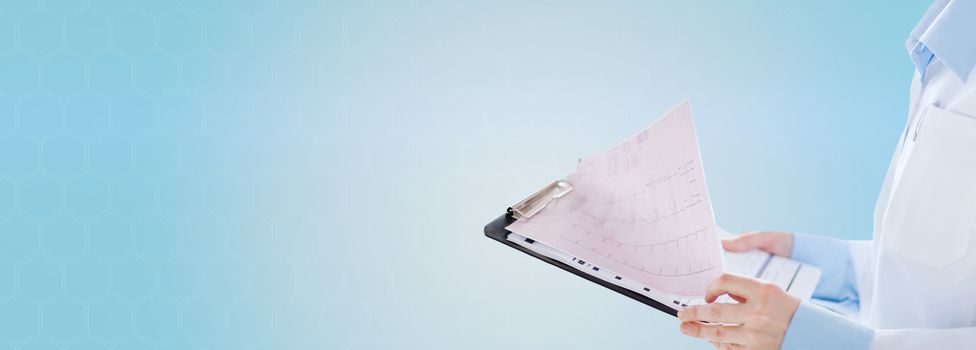 healthcare, cardiology, people and medicine concept - close up of female holding clipboard with cardiogram