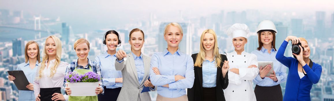 business, people and office concept - happy smiling businessman in suit pointing at you