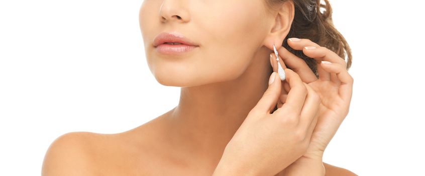 close-up of beautiful woman wearing shiny diamond earrings